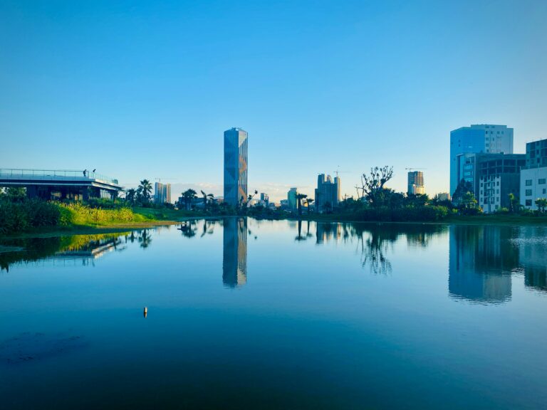 The city of Addis Ababa with a reflective lake and modern architecture in the background.