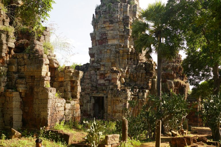 Ancient ruins in Battambang, Cambodia, surrounded by lush greenery.