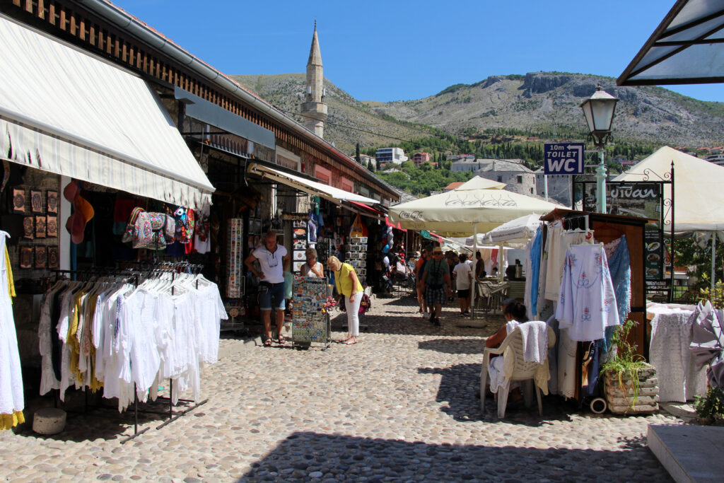 O imagine a vechiului bazar din Mostar prezentând magazine, tarabe și arhitectura tradițională.