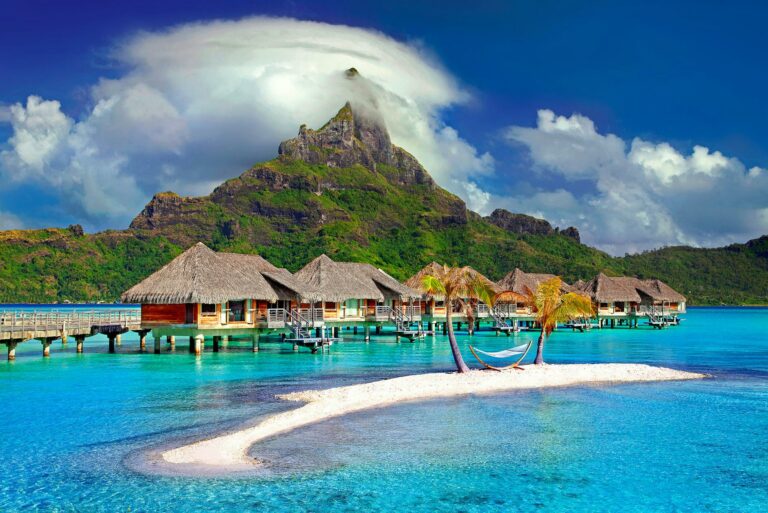 Luxury overwater bungalows on turquoise water in Bora Bora, with Mount Otemanu in the background, French Polynesia.