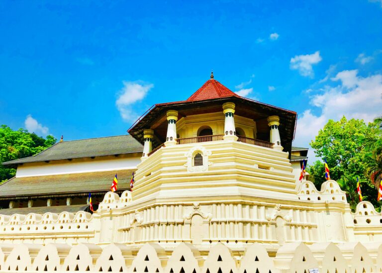 Close-up view of the Temple of the Sacred Tooth Relic in Kandy, Sri Lanka, under clear skies.