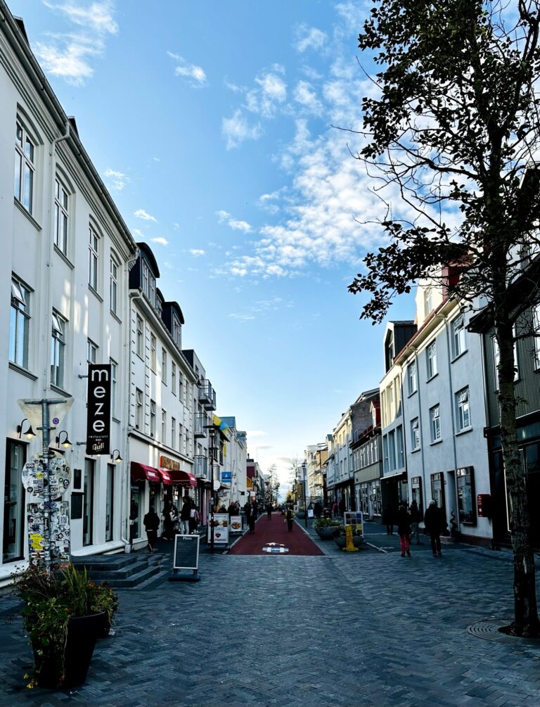 Strada Laugavegur din Reykjavik, cu clădiri albe și cer senin.
