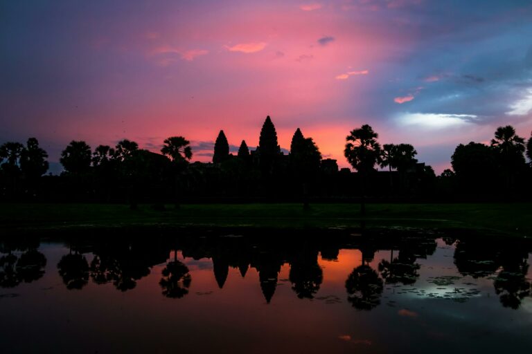 Angkor Wat at sunset, with vibrant sky colors and water reflections, Siem Reap, Cambodia.